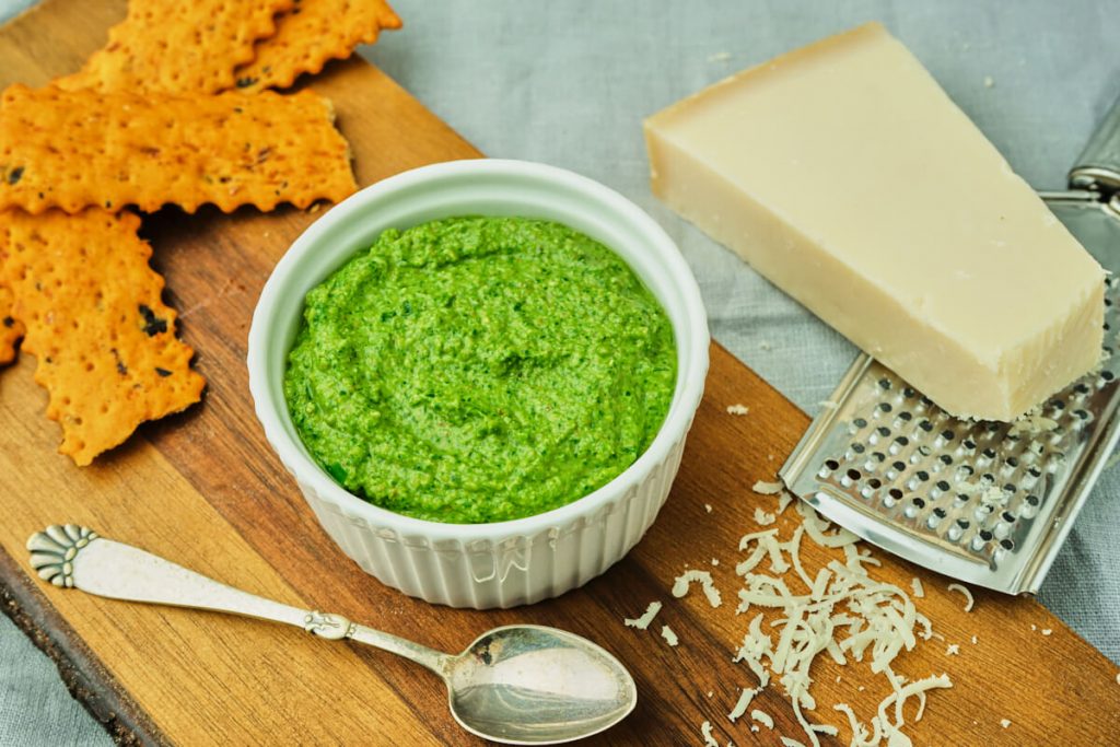 ramsløgspesto på et tapas bord med ost og kiks.