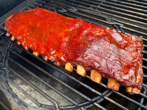 St louis cut spareribs på grillen næsten klar til at spise.