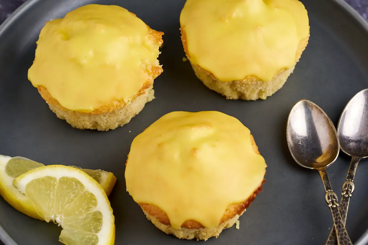 3 citronmuffins med citronglasur på tallerken