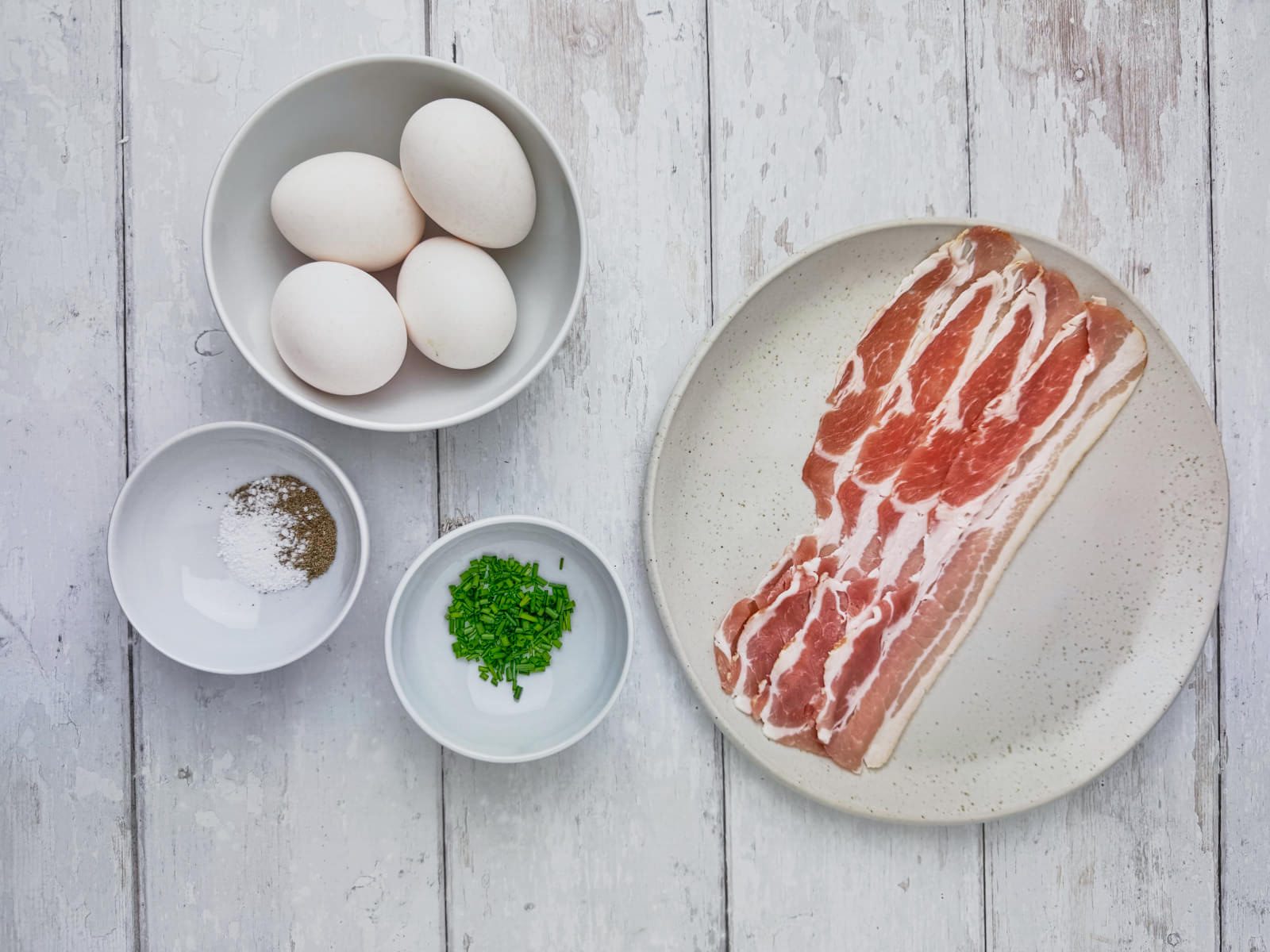 ingredienser til æg og bacon i muffinsforme.