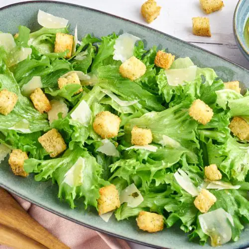 grøn salat med vinaigrette, parmesanflager og brødcroutoner
