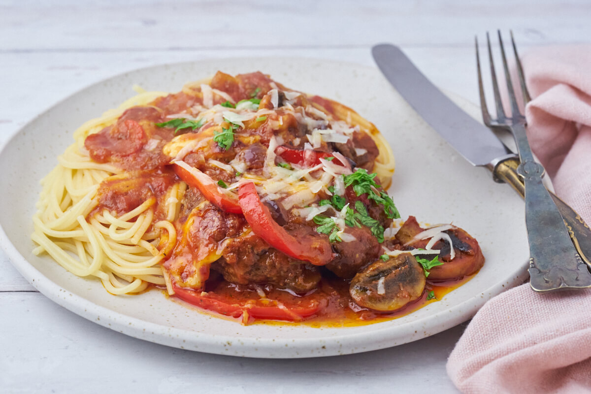 tallerken med pizzabøffer i tomatsauce med kogt spaghetti til.