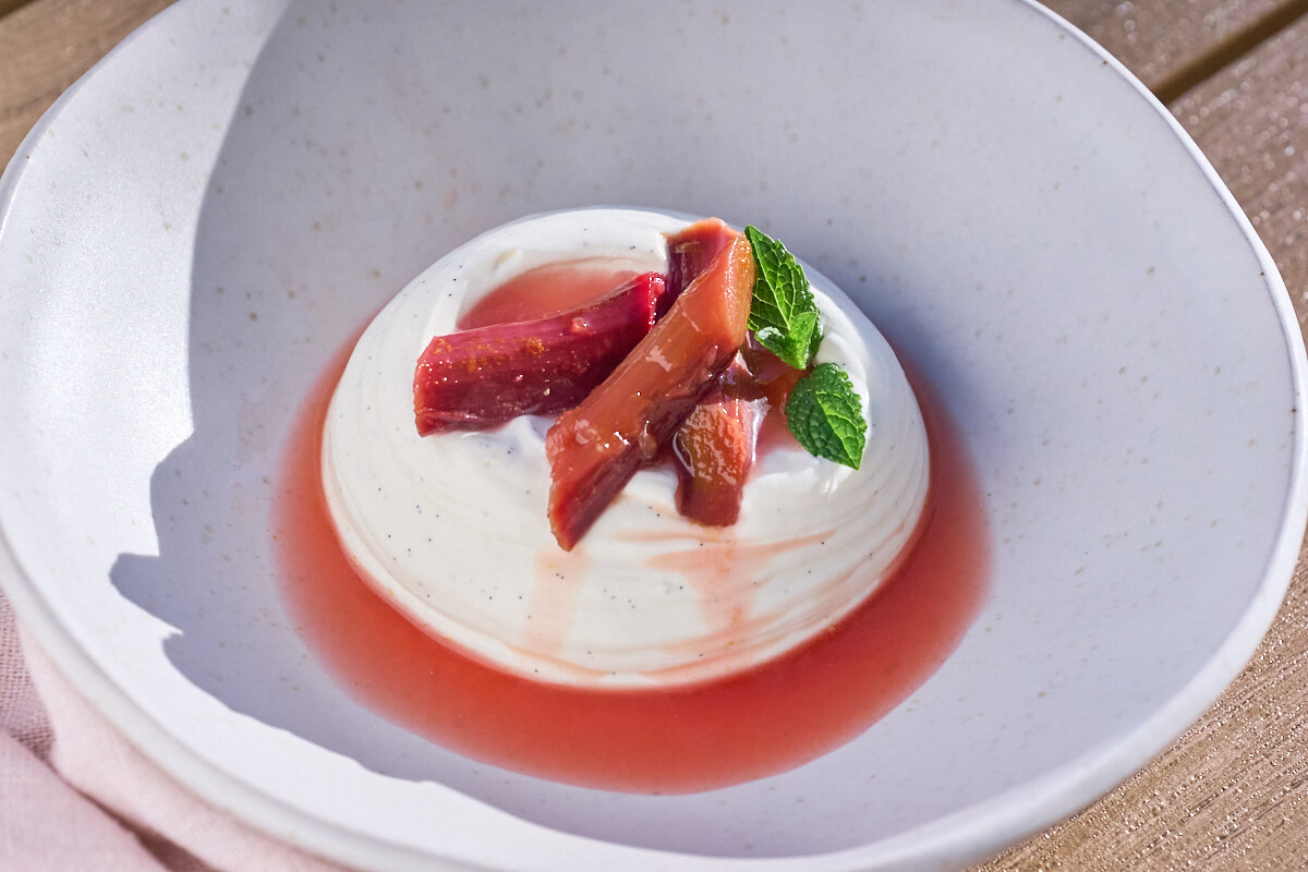 pisket panna cotta med pocherede rabarber klar til servering.
